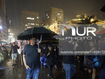 Demonstrators shout slogans as they participate in a protest against Sao Paulo's governor, Tarcisio de Freitas, and the violence of the poli...