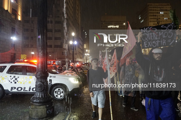 Demonstrators shout slogans as they participate in a protest against Sao Paulo's governor, Tarcisio de Freitas, and the violence of the poli...