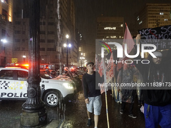 Demonstrators shout slogans as they participate in a protest against Sao Paulo's governor, Tarcisio de Freitas, and the violence of the poli...