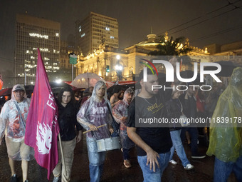 Demonstrators shout slogans as they participate in a protest against Sao Paulo's governor, Tarcisio de Freitas, and the violence of the poli...