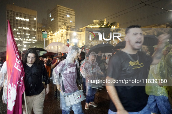 Demonstrators shout slogans as they participate in a protest against Sao Paulo's governor, Tarcisio de Freitas, and the violence of the poli...