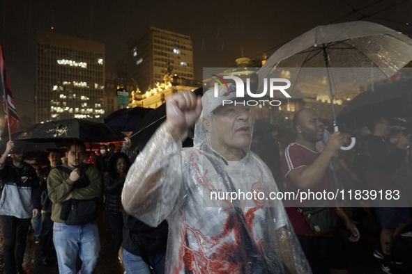 Demonstrators shout slogans as they participate in a protest against Sao Paulo's governor, Tarcisio de Freitas, and the violence of the poli...