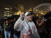 Demonstrators shout slogans as they participate in a protest against Sao Paulo's governor, Tarcisio de Freitas, and the violence of the poli...