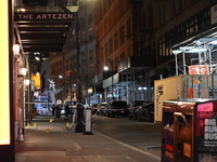 NYPD Crime Scene Unit investigators mark the crime scene where a 17-year-old boy is killed and an 18-year-old man is injured after they are...