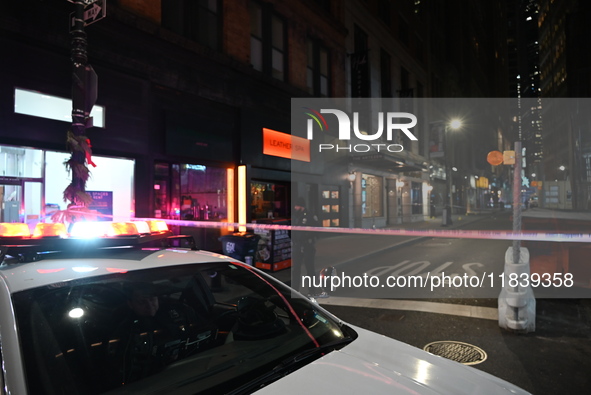 NYPD Crime Scene Unit investigators mark the crime scene where a 17-year-old boy is killed and an 18-year-old man is injured after they are...