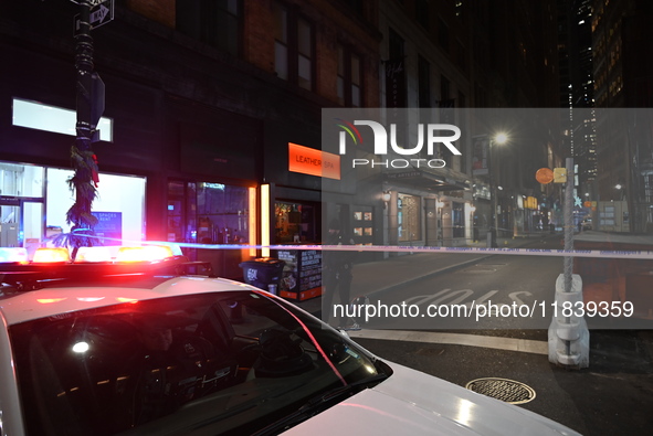 NYPD Crime Scene Unit investigators mark the crime scene where a 17-year-old boy is killed and an 18-year-old man is injured after they are...