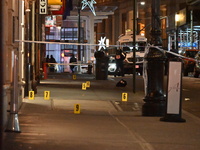 NYPD Crime Scene Unit investigators mark the crime scene where a 17-year-old boy is killed and an 18-year-old man is injured after they are...