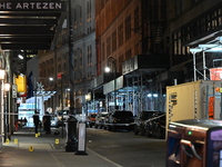 NYPD Crime Scene Unit investigators mark the crime scene where a 17-year-old boy is killed and an 18-year-old man is injured after they are...