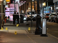 NYPD Crime Scene Unit investigators mark the crime scene where a 17-year-old boy is killed and an 18-year-old man is injured after they are...