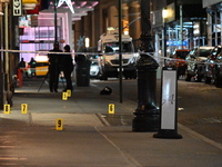 NYPD Crime Scene Unit investigators mark the crime scene where a 17-year-old boy is killed and an 18-year-old man is injured after they are...