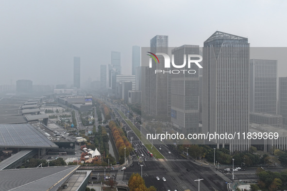 High-rise buildings loom amid heavy fog in Nanjing, Jiangsu province, China, on December 6, 2024. 