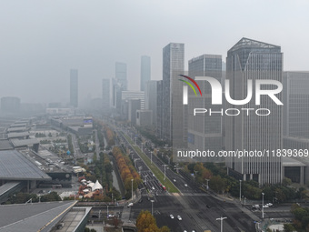 High-rise buildings loom amid heavy fog in Nanjing, Jiangsu province, China, on December 6, 2024. (