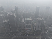 High-rise buildings loom amid heavy fog in Nanjing, Jiangsu province, China, on December 6, 2024. (