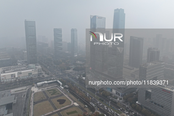 High-rise buildings loom amid heavy fog in Nanjing, Jiangsu province, China, on December 6, 2024. 