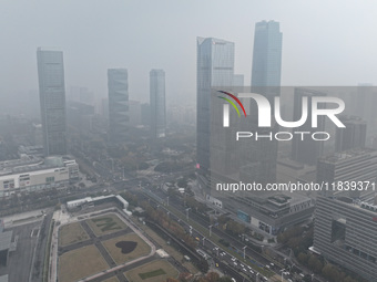 High-rise buildings loom amid heavy fog in Nanjing, Jiangsu province, China, on December 6, 2024. (