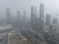 High-rise buildings loom amid heavy fog in Nanjing, Jiangsu province, China, on December 6, 2024. (