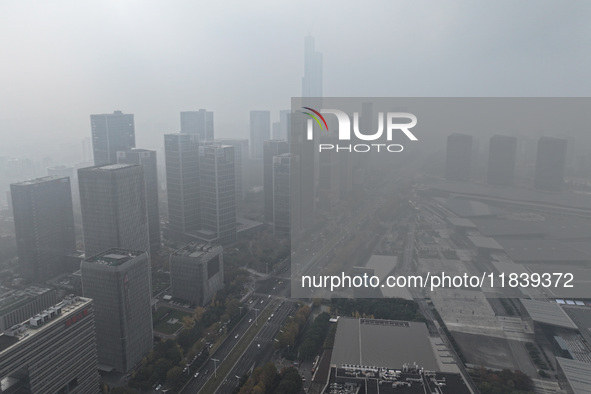 High-rise buildings loom amid heavy fog in Nanjing, Jiangsu province, China, on December 6, 2024. 