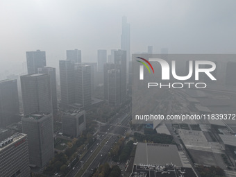 High-rise buildings loom amid heavy fog in Nanjing, Jiangsu province, China, on December 6, 2024. (