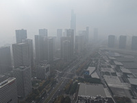 High-rise buildings loom amid heavy fog in Nanjing, Jiangsu province, China, on December 6, 2024. (