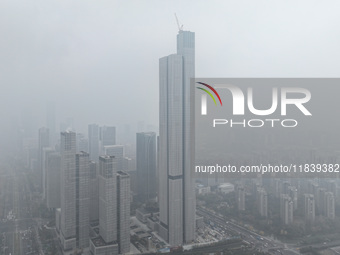 High-rise buildings loom amid heavy fog in Nanjing, Jiangsu province, China, on December 6, 2024. (