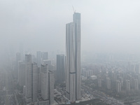 High-rise buildings loom amid heavy fog in Nanjing, Jiangsu province, China, on December 6, 2024. (