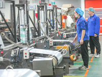 A worker produces environmentally friendly plastic bags at a workshop in Huzhou, China, on December 6, 2024. (