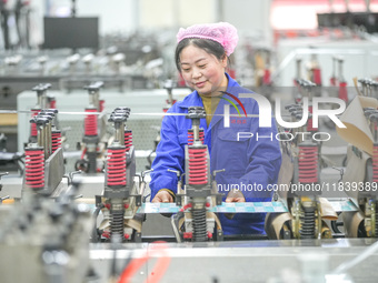 A worker produces environmentally friendly plastic bags at a workshop in Huzhou, China, on December 6, 2024. (