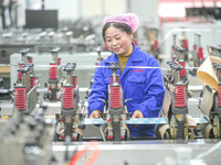 A worker produces environmentally friendly plastic bags at a workshop in Huzhou, China, on December 6, 2024. (