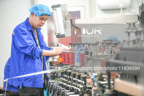 A worker produces environmentally friendly plastic bags at a workshop in Huzhou, China, on December 6, 2024. 