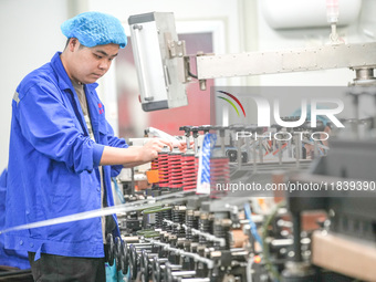 A worker produces environmentally friendly plastic bags at a workshop in Huzhou, China, on December 6, 2024. (