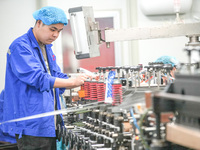 A worker produces environmentally friendly plastic bags at a workshop in Huzhou, China, on December 6, 2024. (