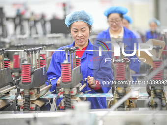 A worker produces environmentally friendly plastic bags at a workshop in Huzhou, China, on December 6, 2024. (