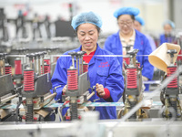 A worker produces environmentally friendly plastic bags at a workshop in Huzhou, China, on December 6, 2024. (