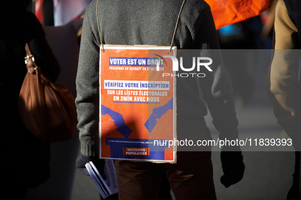 A protester holds a placard reading 'Vote is a right, check your inscription on electoral rolls'. Between 8,000 and 10,000 protesters march...