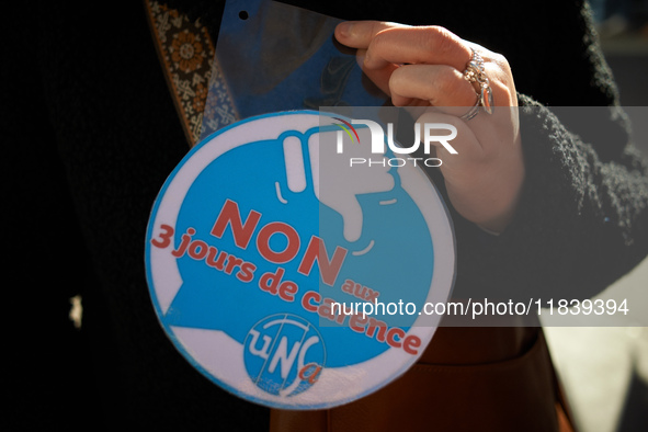 A sticker reads '3 days of waiting period, it's no'. Between 8,000 and 10,000 protesters march in Toulouse, France, on December 5, 2024, cal...