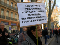 A woman holds a placard reading 'Today's children are tomorrow's citizens'. Between 8,000 and 10,000 protesters march in Toulouse, France, o...