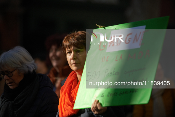 A woman holds a placard reading 'Discontent as 500 jobs will be cut at the Departmental council'. Between 8,000 and 10,000 protesters march...