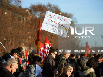 A placard reads 'Black Friday, 500 jobs cut'. Between 8,000 and 10,000 protesters march in Toulouse, France, on December 5, 2024, called by...