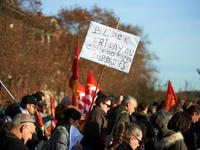 A placard reads 'Black Friday, 500 jobs cut'. Between 8,000 and 10,000 protesters march in Toulouse, France, on December 5, 2024, called by...