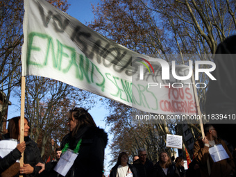 A banner reads 'you, me, us, families, children, seniors, all affected'. Between 8,000 and 10,000 protesters march in Toulouse, France, on D...