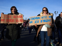 Two women hold placards reading 'The school of the future must respect its teachers' (L) and 'Education isn't a money game' (R). Between 8,0...