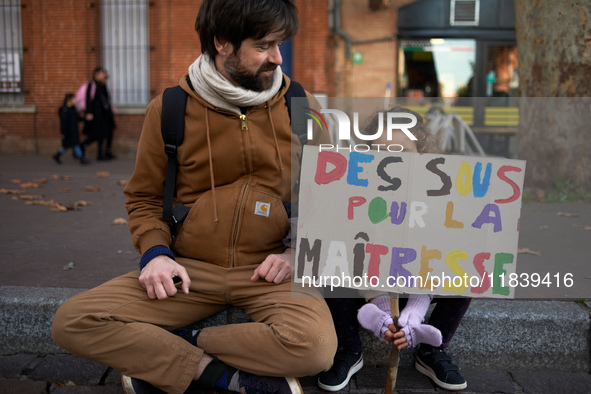 A young girl holds a placard reading 'money for my schoolteacher'. Between 8,000 and 10,000 protesters march in Toulouse, France, on Decembe...