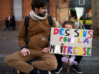 A young girl holds a placard reading 'money for my schoolteacher'. Between 8,000 and 10,000 protesters march in Toulouse, France, on Decembe...