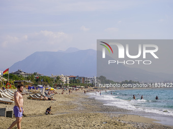 Tourists relax on beach loungers on the beach of the Mediterranean Sea in Alanya, Turkey, on November 3, 2024 (