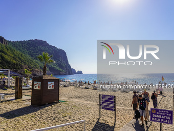 Tourists relax on Damlatas Beach of the Mediterranean Sea in Alanya, Turkey, on November 3, 2024 (