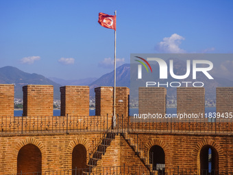 The Turkish flag on the top of the Red Tower is seen in Alanya, Turkey, on November 5, 2024. (