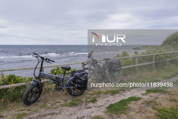 A general view of the Baltic Sea coast with electric bicycles in the foreground is seen on Bornholm Island, Denmark, on August 5, 2024 