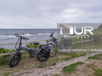 A general view of the Baltic Sea coast with electric bicycles in the foreground is seen on Bornholm Island, Denmark, on August 5, 2024 (