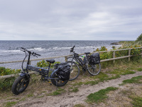 A general view of the Baltic Sea coast with electric bicycles in the foreground is seen on Bornholm Island, Denmark, on August 5, 2024 (