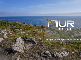 A high rocky cliff on the Baltic Sea coast near Hammershus Castle is seen on Bornholm Island, Denmark, on August 5, 2024. (